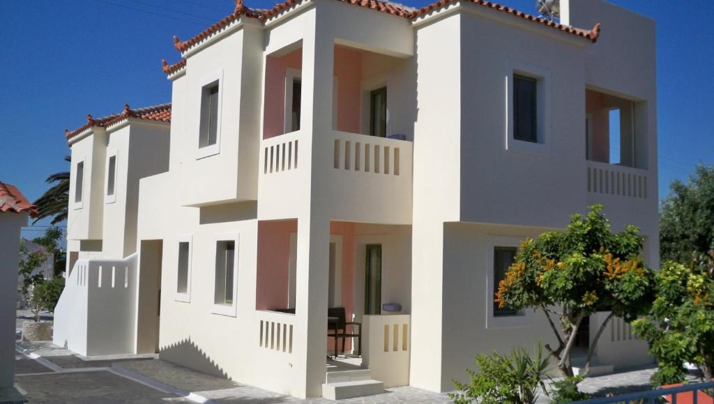 a large white house with a lot of windows at Aphrodite Samos Suites in Marathokampos