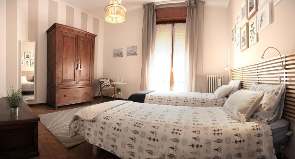 a bedroom with two beds and a dresser at Goga&Romeo in Pesaro