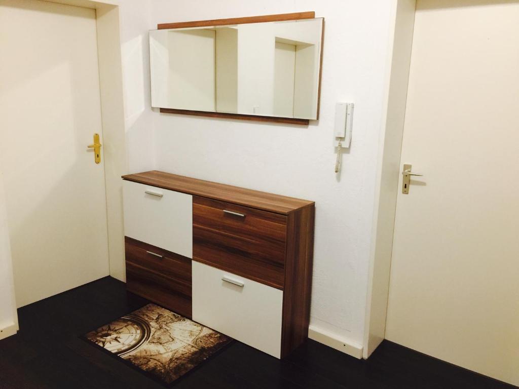 a bathroom with a dresser and a mirror on the wall at Ferienwohnung Dhillon in Bernau am Chiemsee