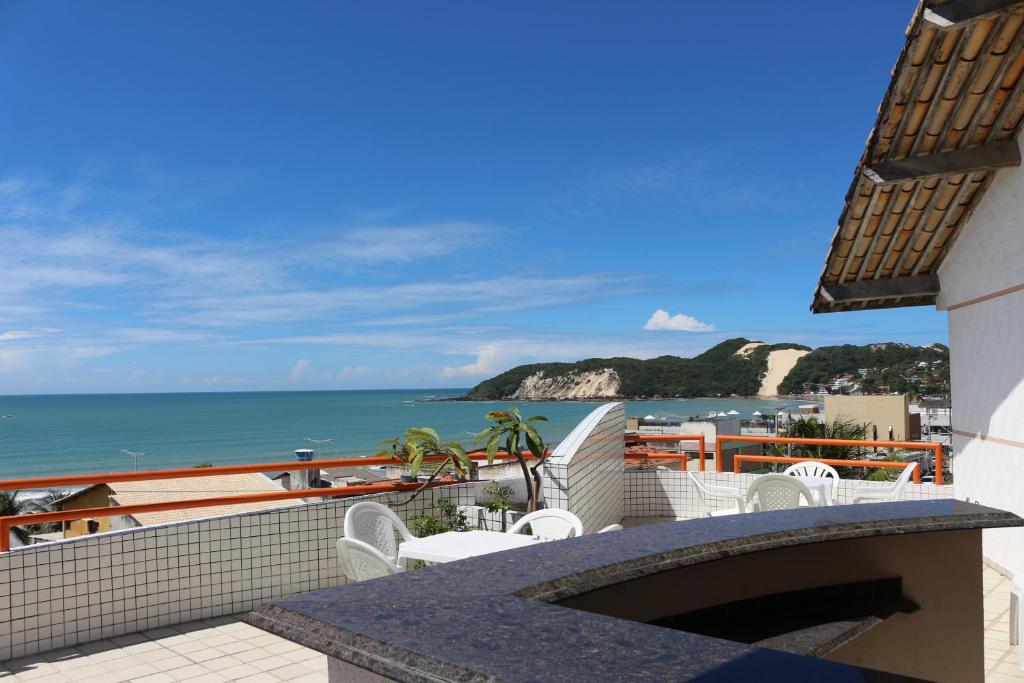 a balcony with a view of the ocean at Marambaia Apart Hotel in Natal