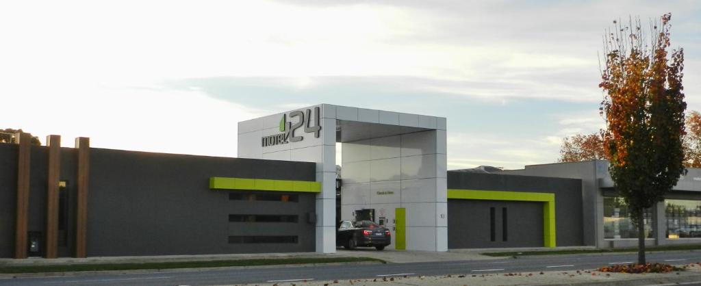 a large white building with a large mirror on the side of the building at Motel 24 in Wodonga