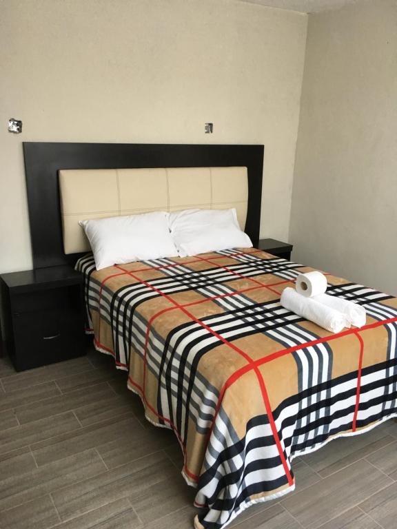Postel nebo postele na pokoji v ubytování Hotel Coatlicue