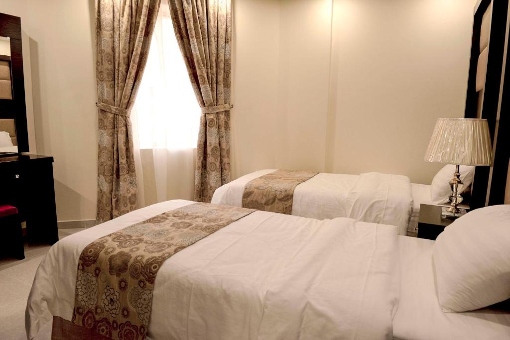 Krevet ili kreveti u jedinici u okviru objekta Rolana Furnished Apartments