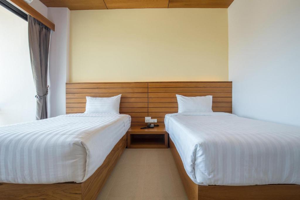 Postel nebo postele na pokoji v ubytování Sann View Hotel