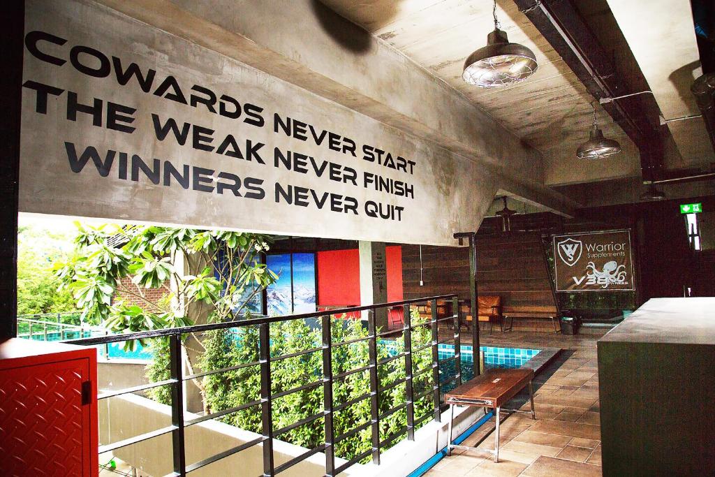 An elevated dining area overlooking greenery, with communal seating and a branded counter.
