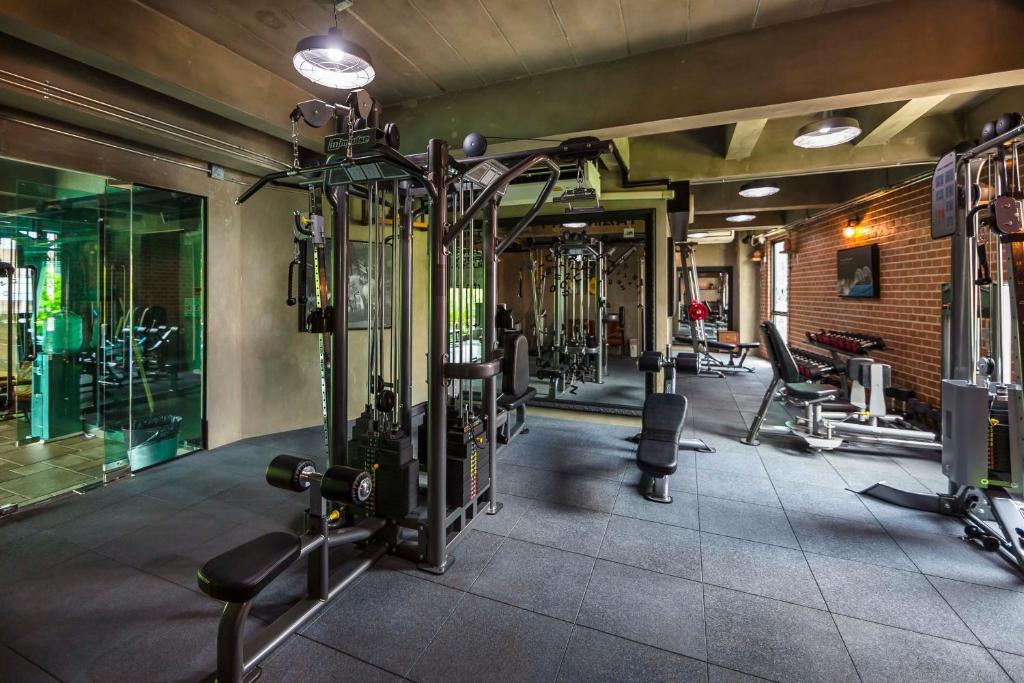 A substantial indoor fitness room with multiple resistance and cardio machines.
