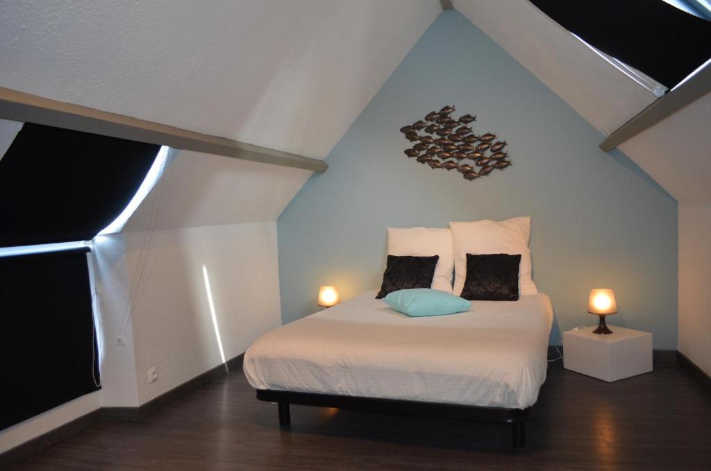 a bedroom with a bed with two lamps on it at Maison Coetquen in Saint Malo