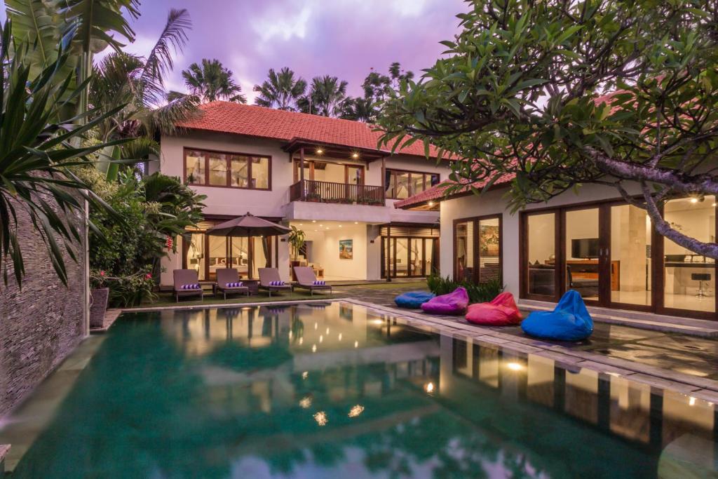 an exterior view of a villa with a swimming pool at Amore Villas in Canggu