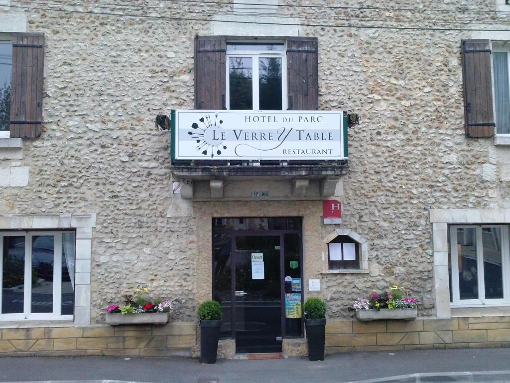 a building with a sign on the front of it at Hotel du parc in Vergt