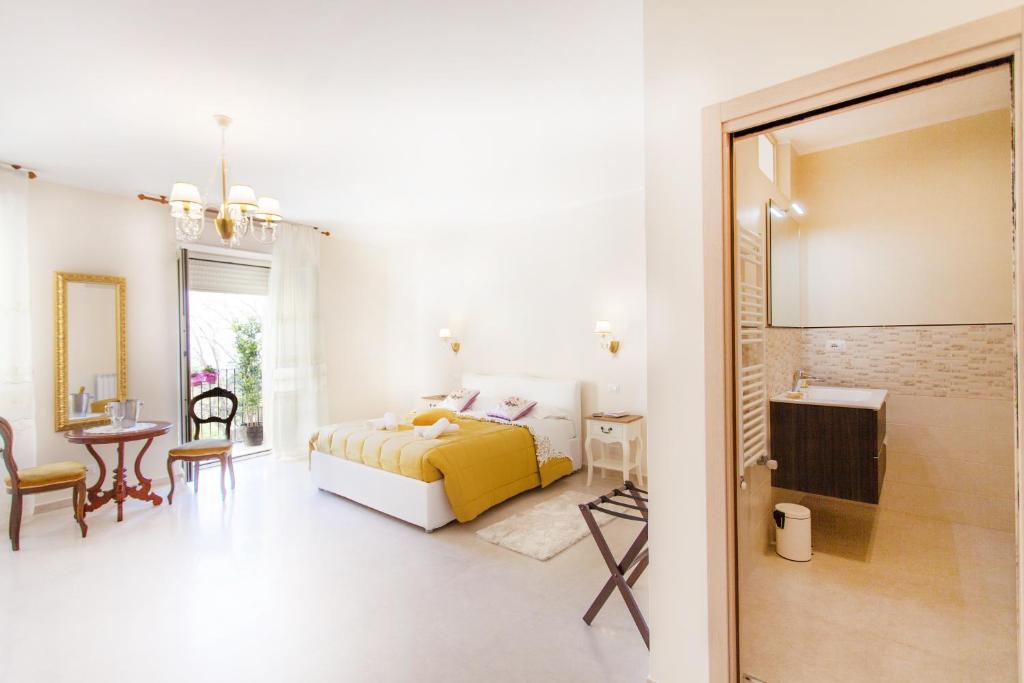 a bedroom with a bed and a room with a table at B&B Veronicas in Taormina