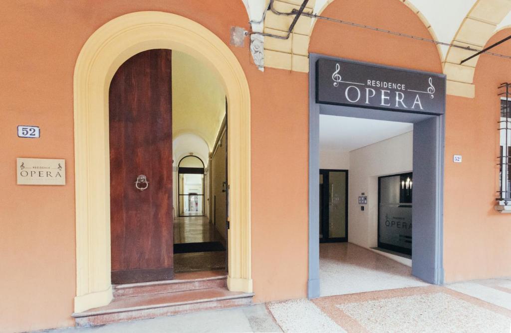 a hallway with an open sign on the side of a building at Opera Residence in Bologna