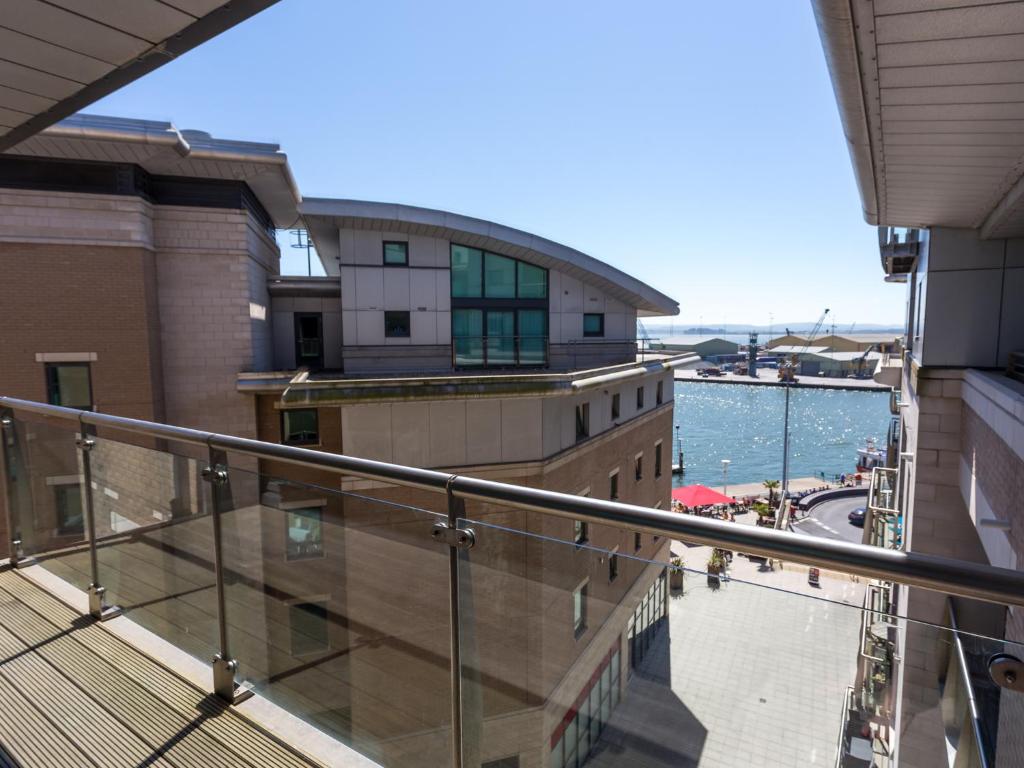 a balcony of a building with a view of the water at Jibe Ho in Poole