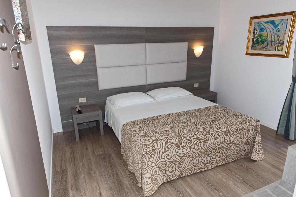 Postel nebo postele na pokoji v ubytování Hotel Sirenetta