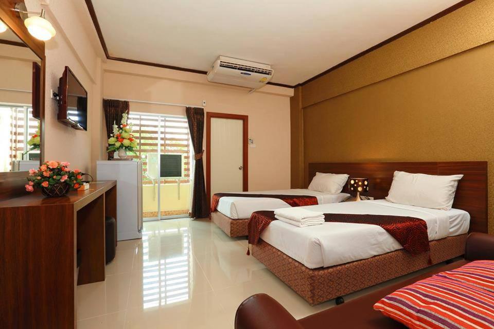 A bed or beds in a room at Hatyai Genting Hotel