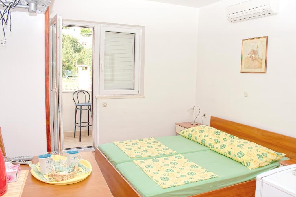 Postel nebo postele na pokoji v ubytování Apartments Dani