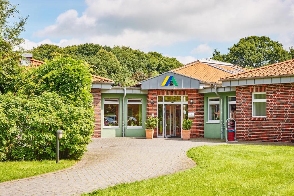 a brick building with aaa sign on the front at Jugendherberge Jever in Jever