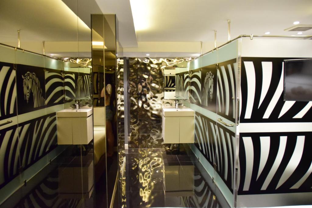 a bathroom with two sinks and black and white stripes at Double Five in Bangkok