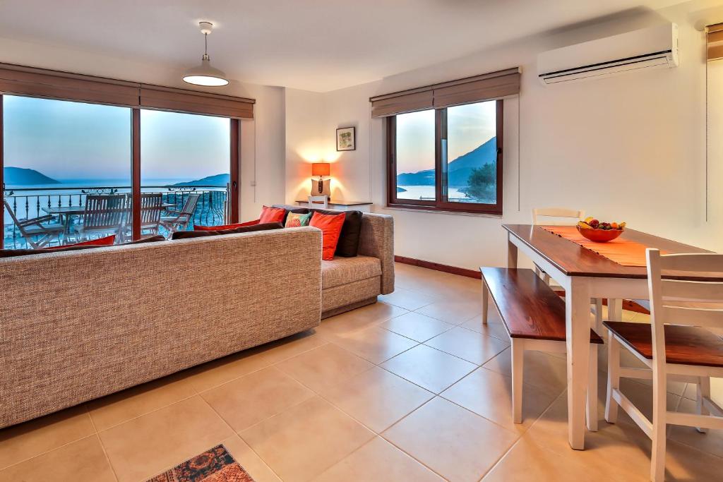 a living room with a couch and a table at Kasinn Apart Turuncu in Kaş