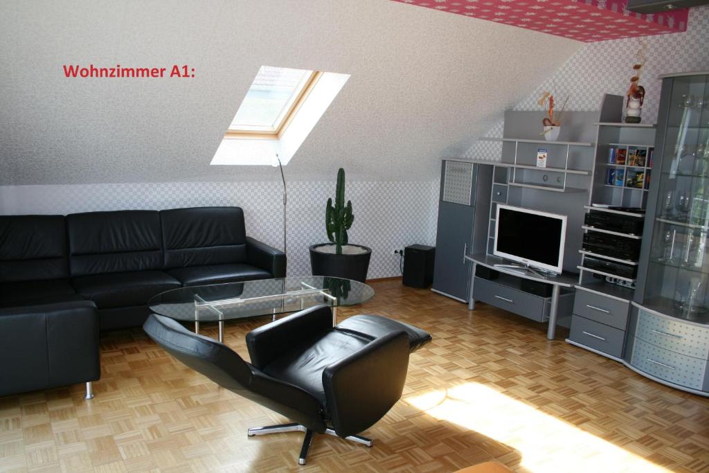 a living room with a couch and a glass table at Ferienwohnungen 99a in Weimar