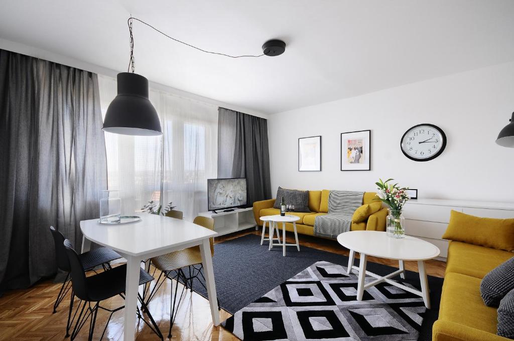 a living room with a couch and a table at A Place Like Home Apartamenty Witosa in Gdańsk