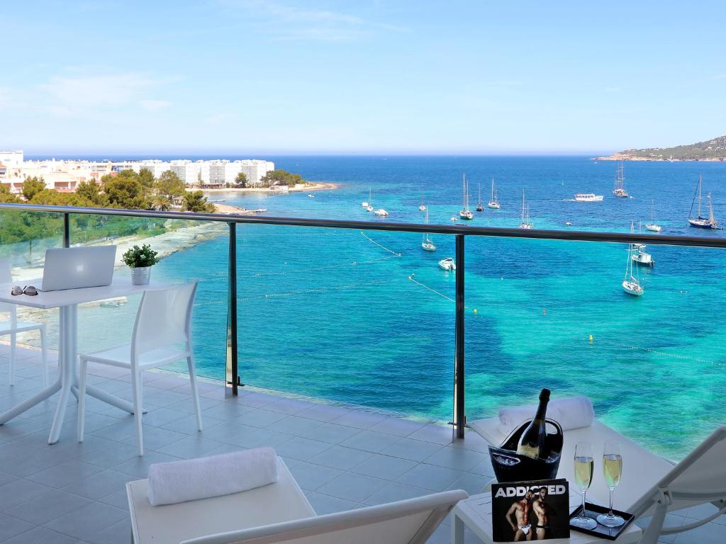 a balcony with a view of the ocean at Axel Beach Ibiza - Adults Only in San Antonio Bay