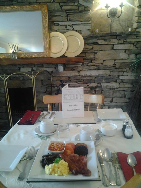 a table with a plate of food on it at Sea Lodge B&B in Durrus