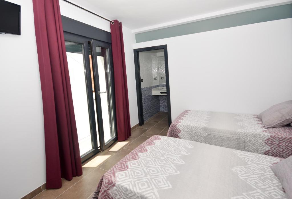 Posteľ alebo postele v izbe v ubytovaní Hostal Maria Jose