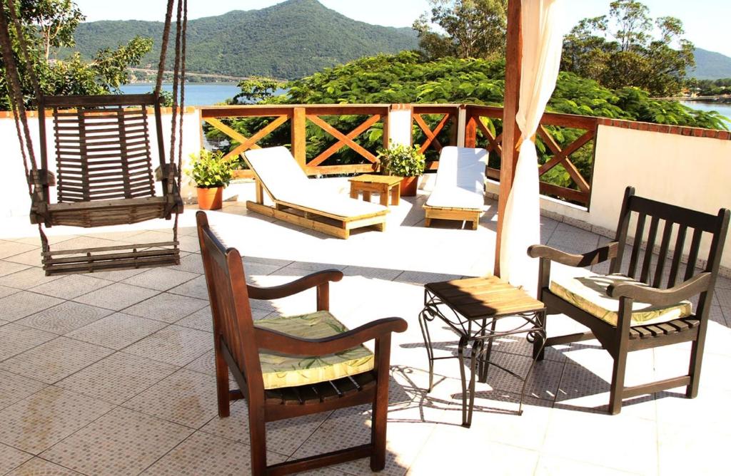 a group of chairs and tables on a patio at Pousada Green in Florianópolis