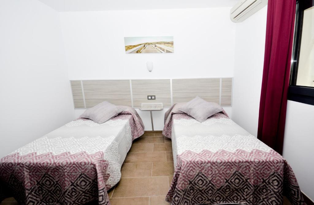 Posteľ alebo postele v izbe v ubytovaní Hostal Maria Jose