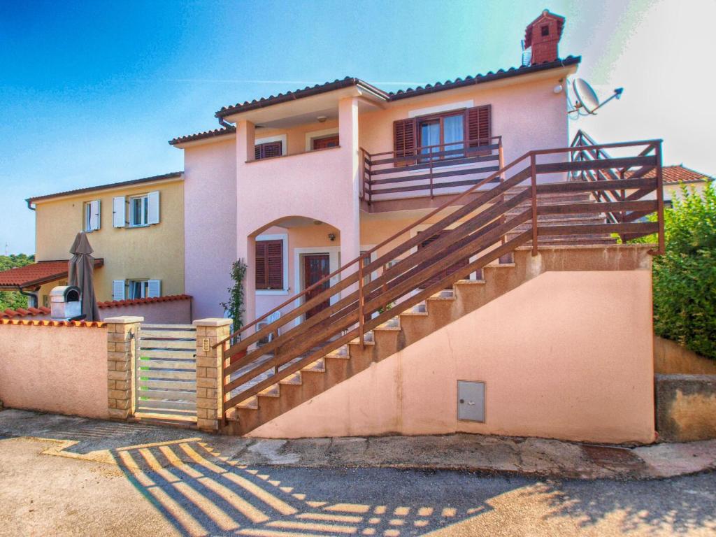 a house with a staircase in front of it at Apartment Loredana 1209 in Banjole