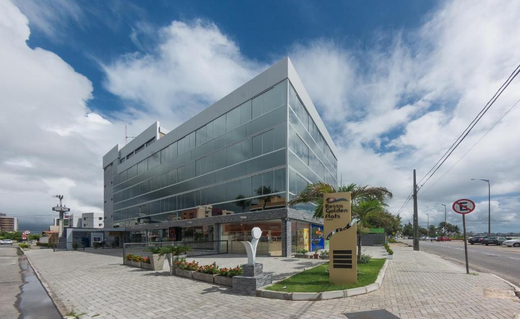 a large glass building on a city street at Bessa Golden Flats in João Pessoa