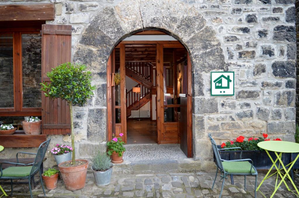 an entrance to a stone building with a table and chairs at Tetxe B&B Roncal in Roncal