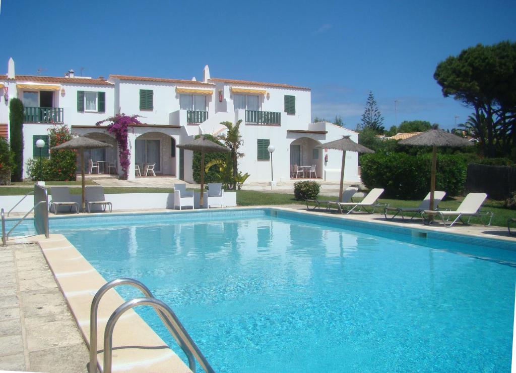 a swimming pool in front of a house at Nure Mar y Mar in Cala en Blanes