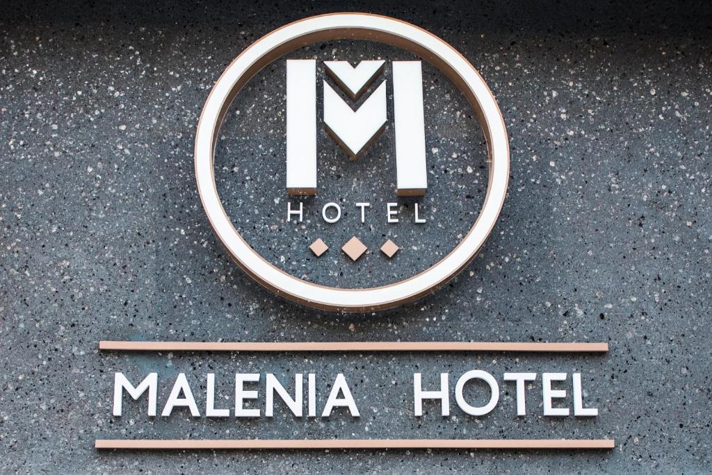 a sign for a malaika hotel on the street at Malenia Hotel in Tolo