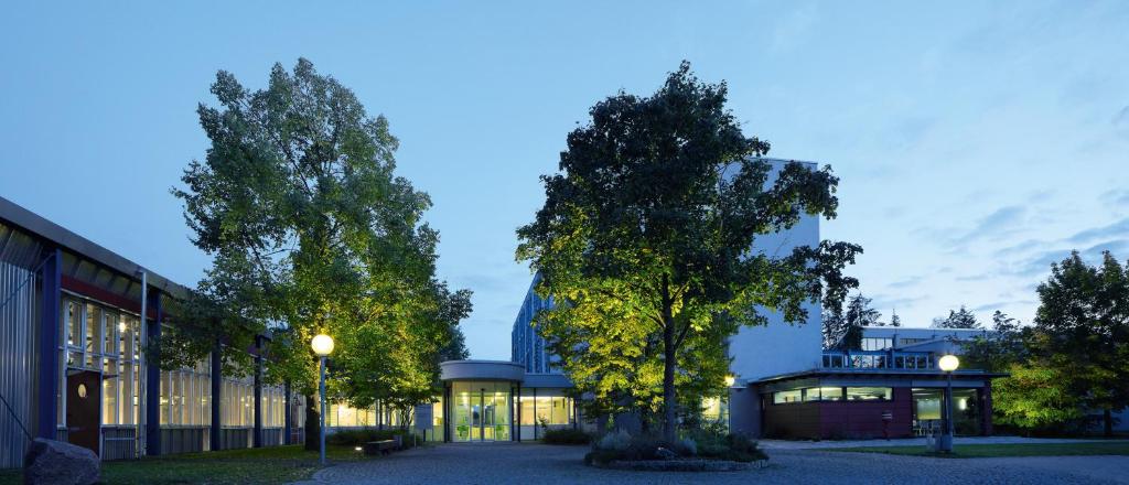 ein Gebäude mit einem Baum davor in der Unterkunft bfwhotel und Tagungszentrum in Nürnberg