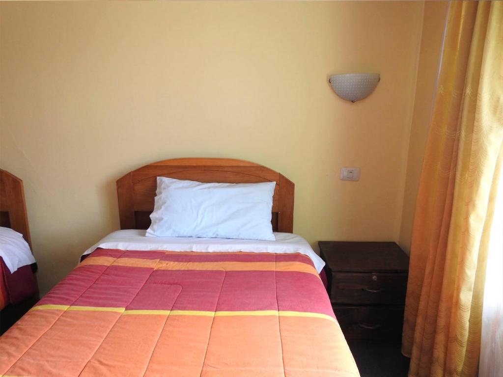 Postel nebo postele na pokoji v ubytování Hostal Lucerito