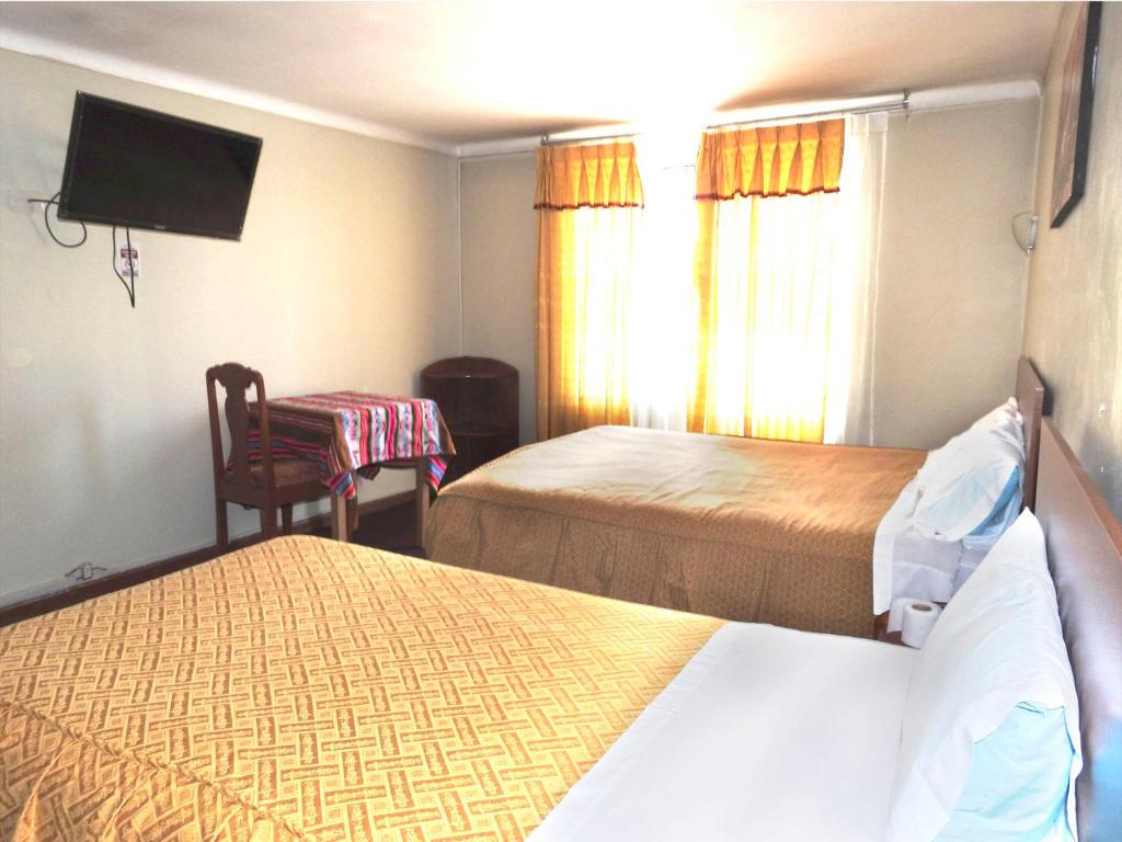 Postel nebo postele na pokoji v ubytování Hostal Lucerito