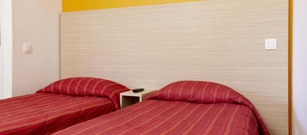 Postel nebo postele na pokoji v ubytování Hotel HECO Lyon sud Vienne