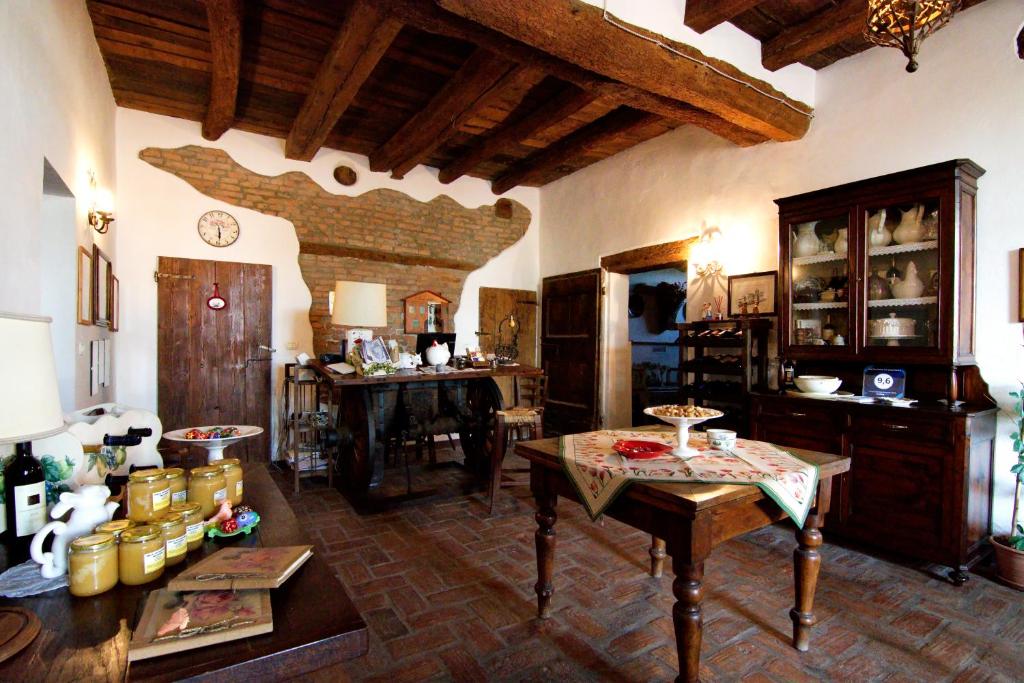 a living room with a table and a dining room at Agriturismo La Cascinetta in Pieve di Cento