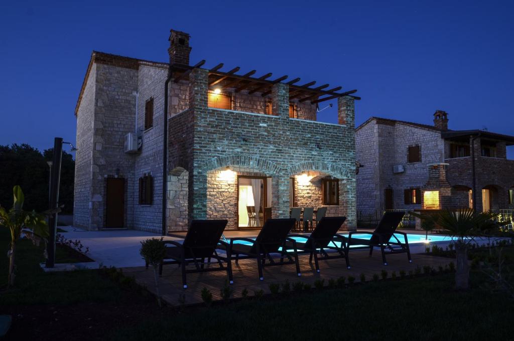 a group of chairs sitting in front of a building at Villa Harmony in Paradise in Svetvinčenat