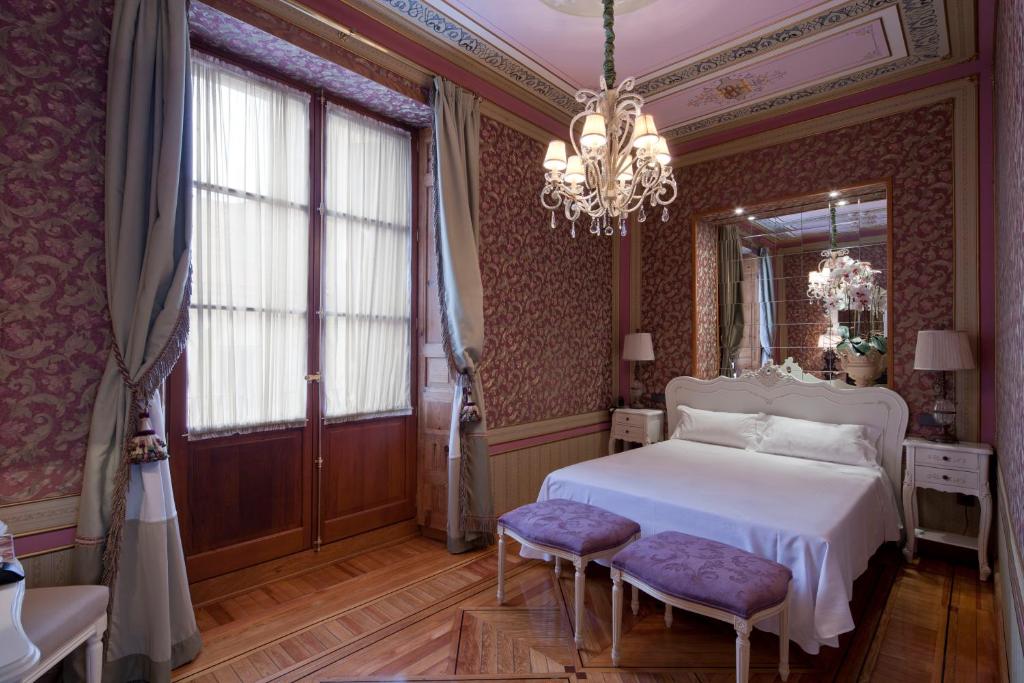 Postel nebo postele na pokoji v ubytování Posada Real Los Cinco Linajes