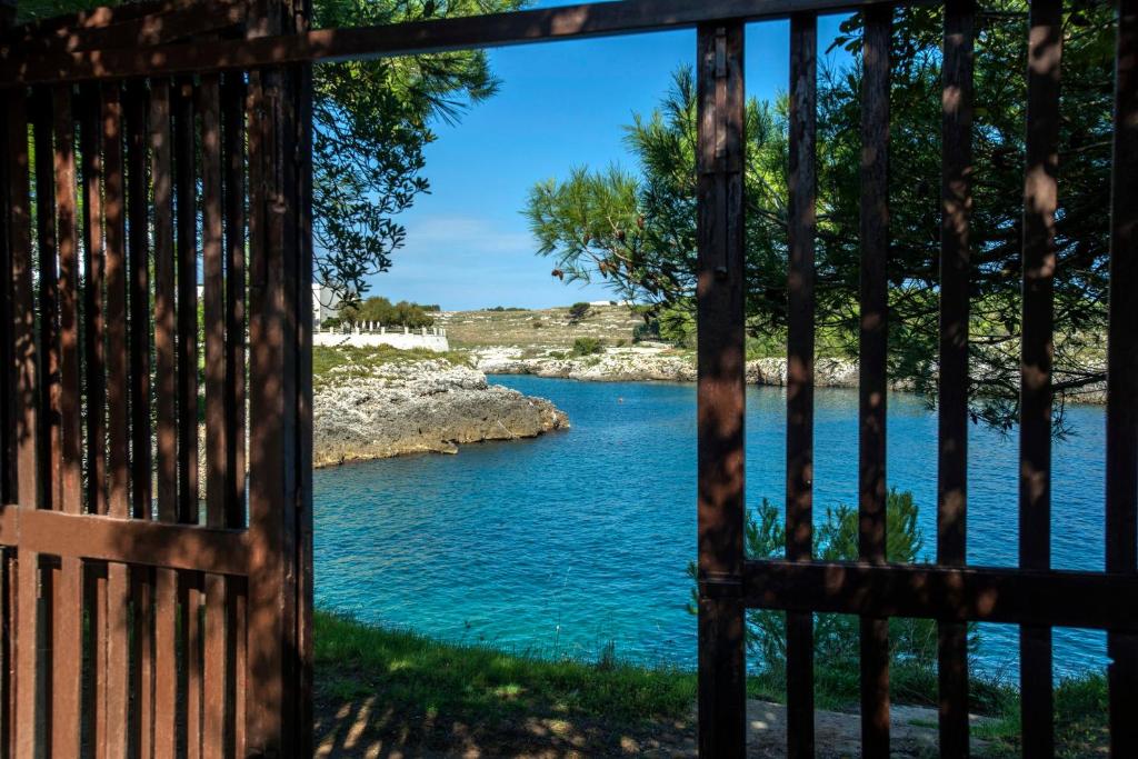 a view of a river through a gate at la casa nell'acqua in Otranto