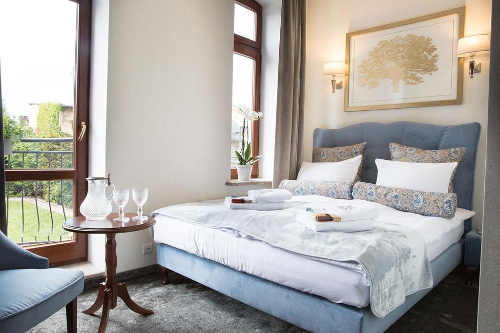 a bedroom with a blue bed with two plates of food on it at Villa Mistral in Ustka