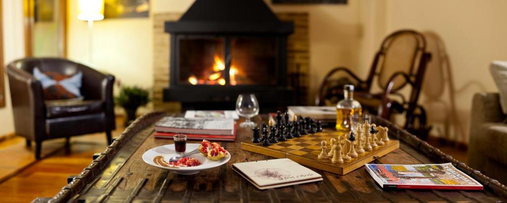 a chess set on a table in a living room with a fireplace at La Font D'Alcala in Alcalá de la Jovada
