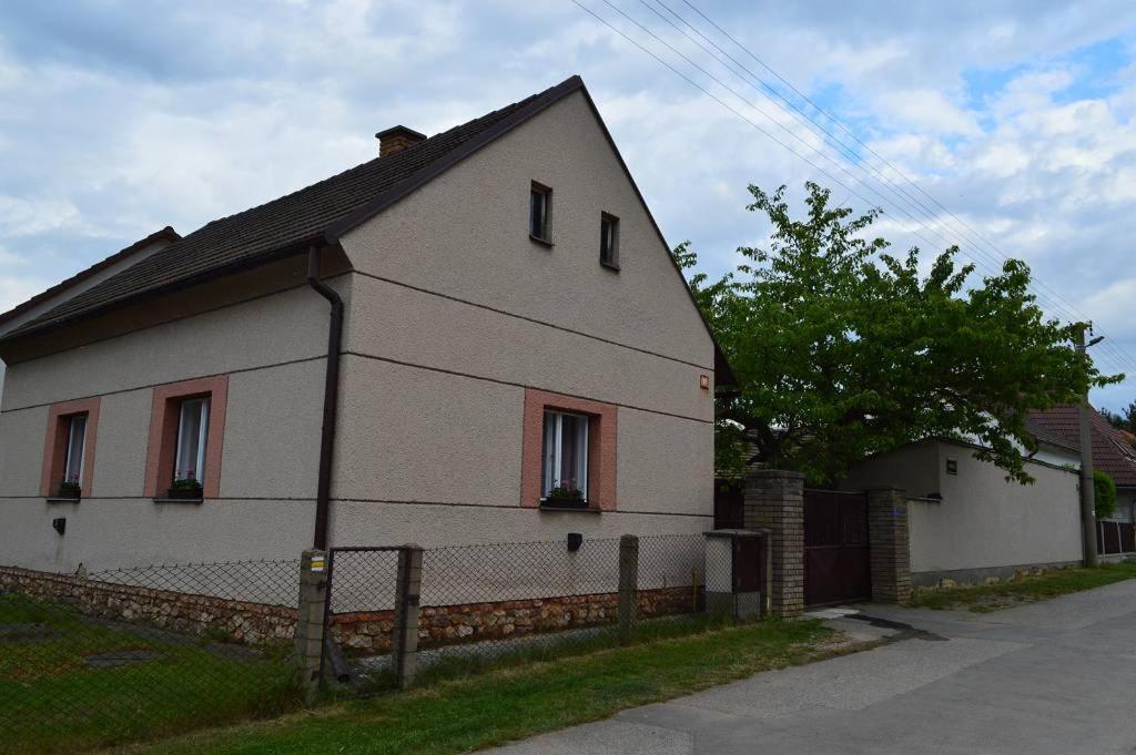 uma casa branca com uma cerca à frente. em U Lokálky em Zadní Třebaň