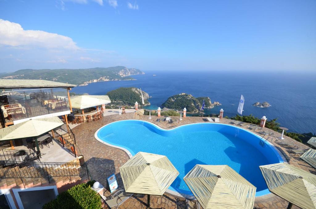 an aerial view of a resort with a swimming pool at Golden Fox Studios and Suites in Lákones