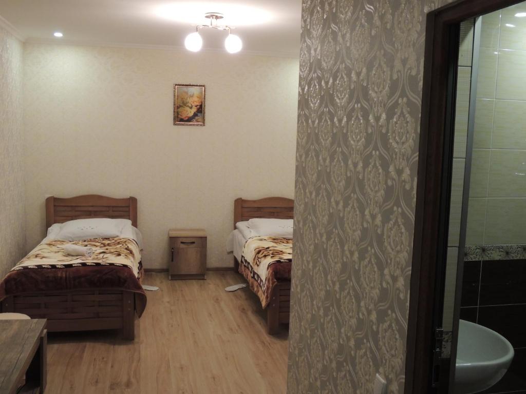 Postel nebo postele na pokoji v ubytování Roza Guesthouse