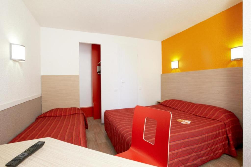 Postel nebo postele na pokoji v ubytování Hotel HECO Lyon sud Vienne