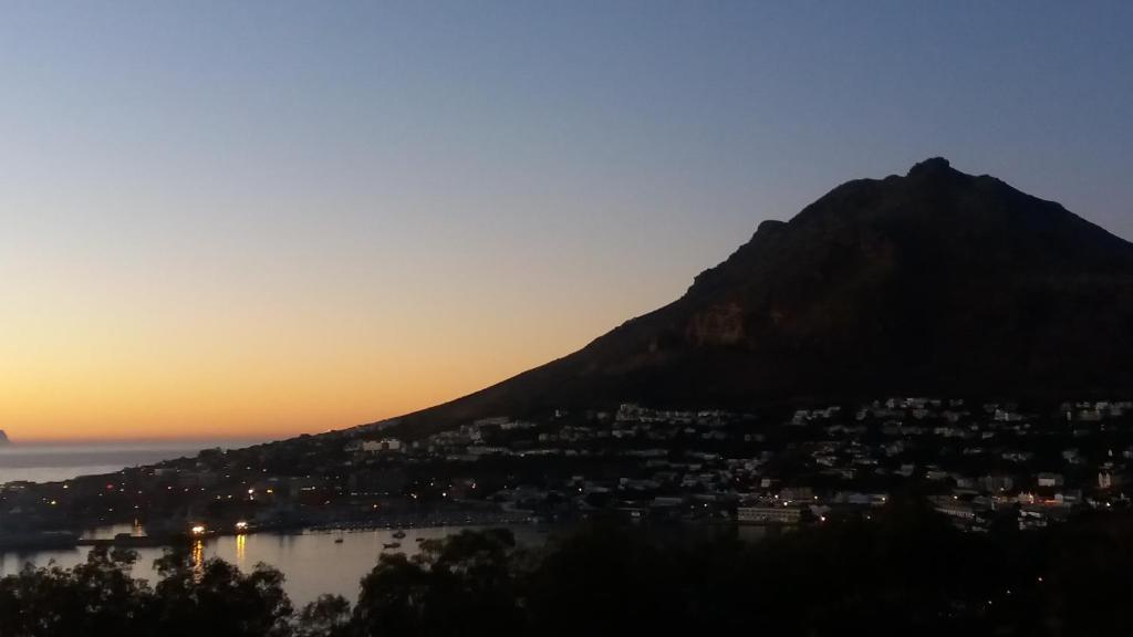 a view of a city and a mountain at sunset at Bayview Heights Gem in Simonʼs Town