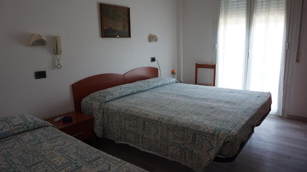 Postel nebo postele na pokoji v ubytování Hotel Daria